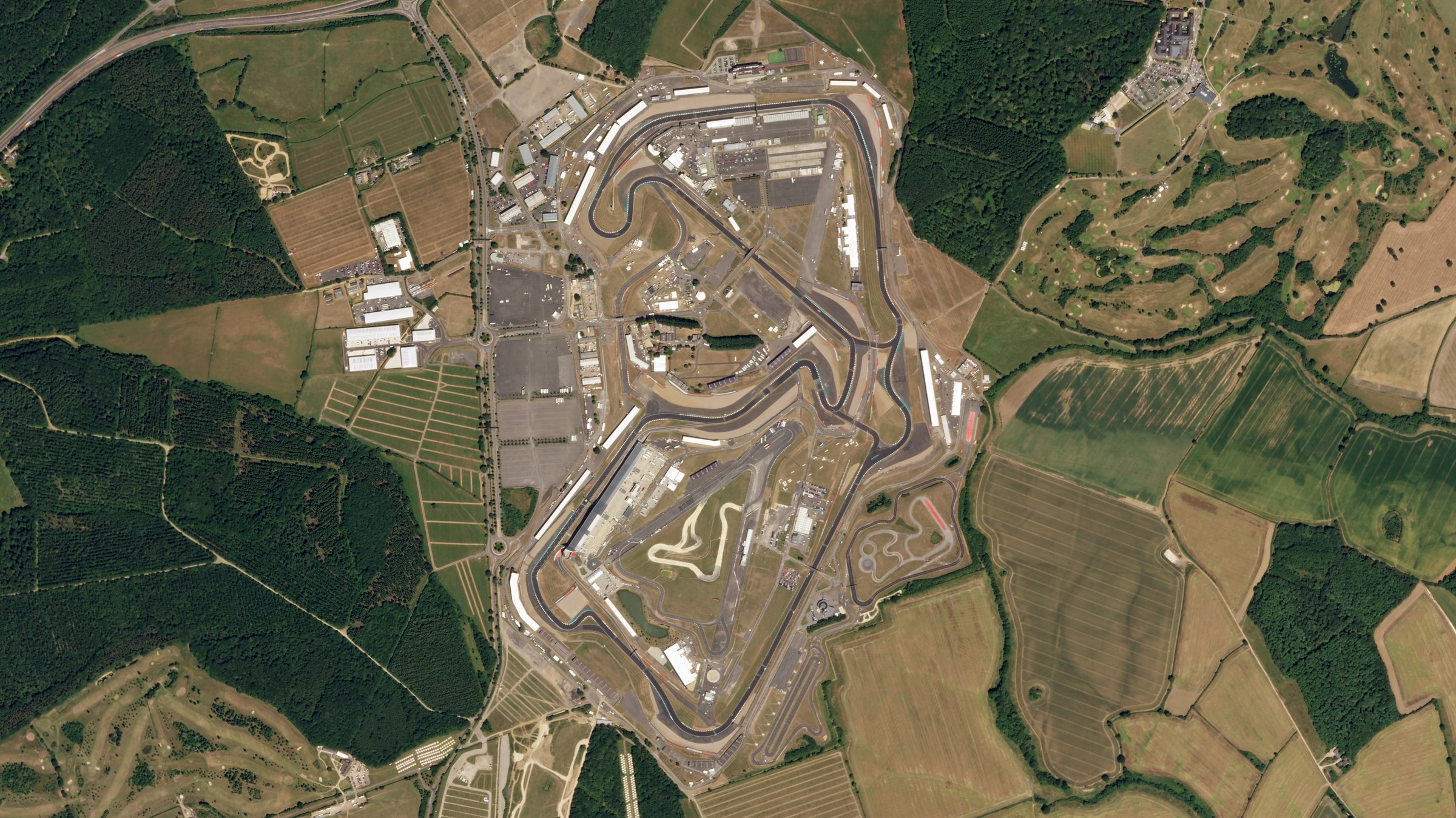 Satellite view of Silverstone Circuit showing the full track layout and surrounding Northamptonshire farmland