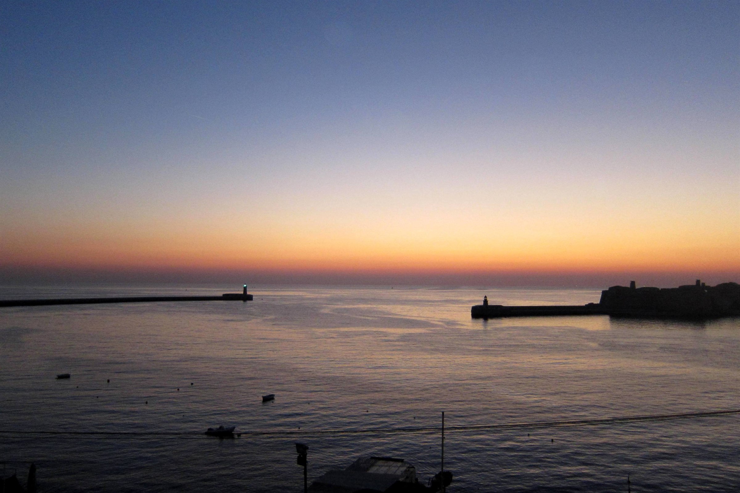 The breakwater lighthouses at the entrance to the Grand Harbour in Valletta Malta at dusk
