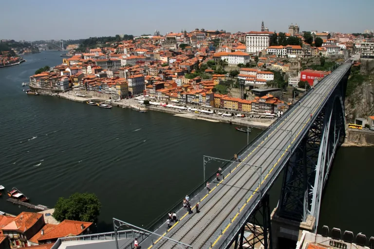 The upper deck of the Dom Luis I bridge in Porto with the Ribeira waterfront and old town across the Douro
