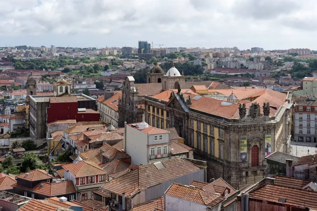 View over Porto rooftops and church domes from Torre dos Clerigos with the port lodges of Gaia beyond