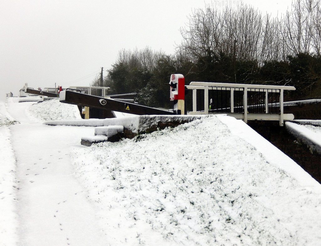 Snow covering the towpath and lock gates of the staircase flight at Foxton Locks in Leicestershire