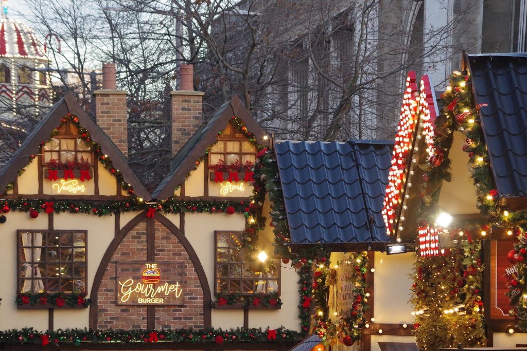 Decorated food chalets with garlands and red bows at Nottingham Winter Wonderland in Old Market Square